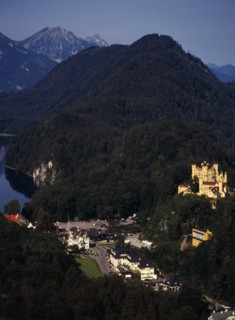 Germany, Bayern, Schwangau, View looking down on town overlooked by Schloss Hohenschwangau and