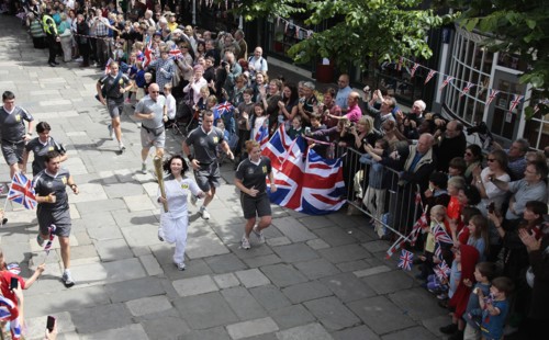 England, Kent, Tunbridge Wells, Olympic Torch relay running through the Pantiles. Photo : Sean