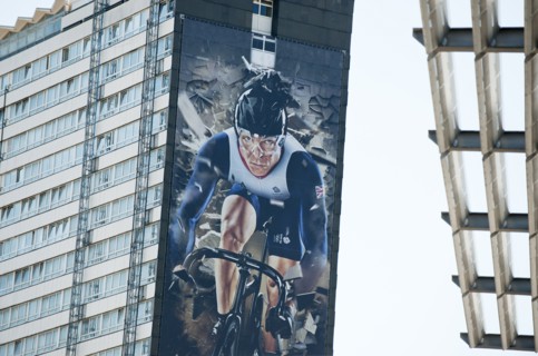 Giant mural of UK cyclist, Sir Chris Hoy covers the side of a block of flats