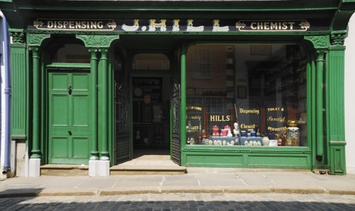 Ireland, County Tyrone, Omagh, Ulster American Folk Park 19th century street Hills chemist
