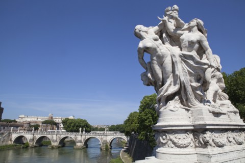 Italy, Lazio, Rome, Statue on the Ponte Vittorio Emanuele with Castel Sant Angelo in the background