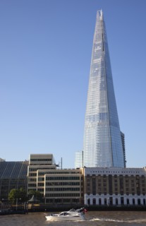 England, London, Southwark southbank Pleasure boat passing the Shard skyscraper designed by Renzo