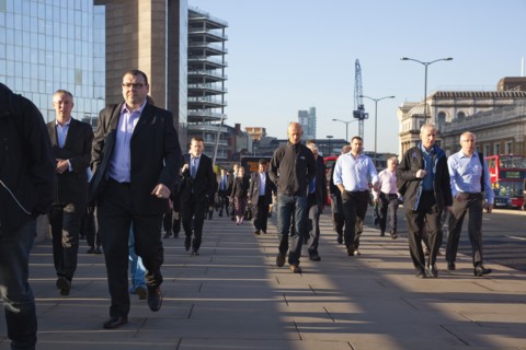 England, London, Early morning commuters crossing London Bridge towards the City Financial district