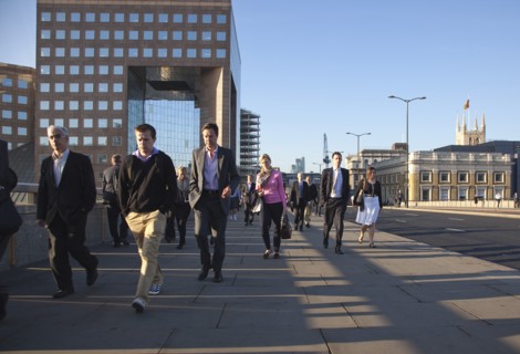 England, London, Early morning commuters crossing London Bridge towards the City Financial district
