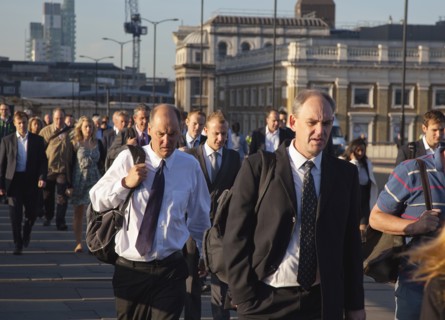 England, London, Early morning commuters crossing London Bridge towards the City Financial district