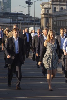 England, London, Early morning commuters crossing London Bridge towards the City Financial district