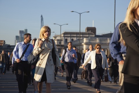 England, London, Early morning commuters crossing London Bridge towards the City Financial district