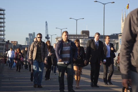 England, London, Early morning commuters crossing London Bridge towards the City Financial district