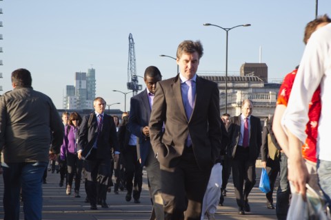 England, London, Early morning commuters crossing London Bridge towards the City Financial district