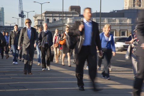 England, London, Early morning commuters crossing London Bridge towards the City Financial district