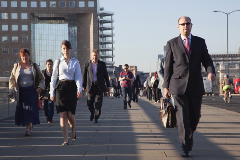 England, London, Early morning commuters crossing London Bridge towards the City Financial district