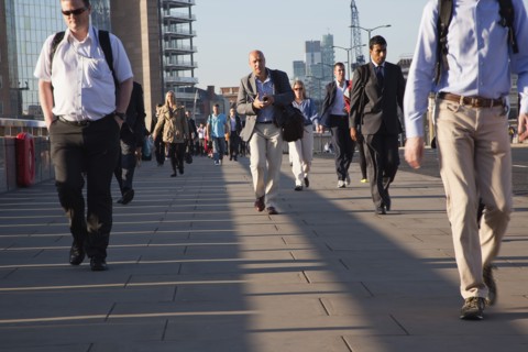 England, London, Early morning commuters crossing London Bridge towards the City Financial district