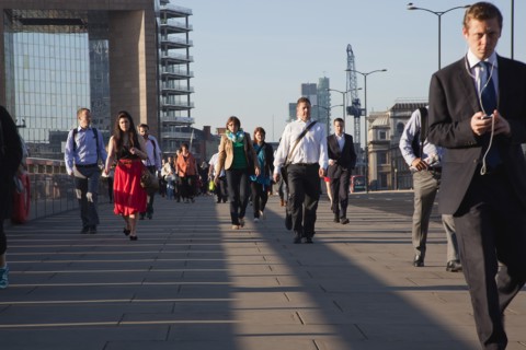 England, London, Early morning commuters crossing London Bridge towards the City Financial district