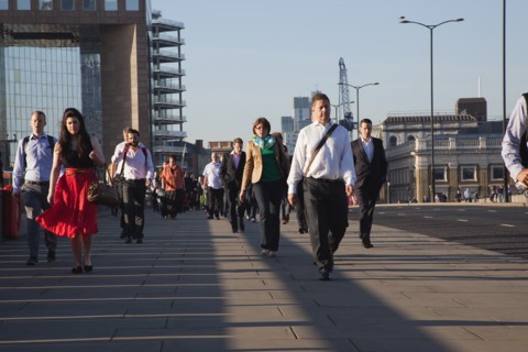 England, London, Early morning commuters crossing London Bridge towards the City Financial district
