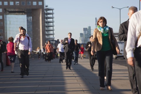 England, London, Early morning commuters crossing London Bridge towards the City Financial district