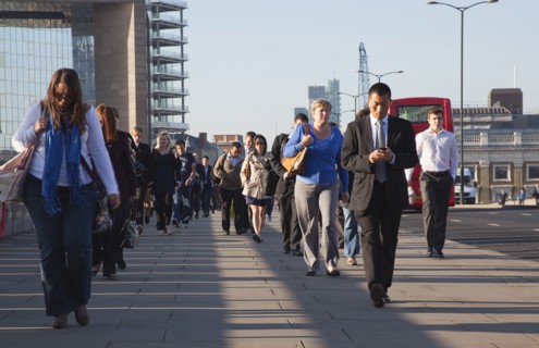 England, London, Early morning commuters crossing London Bridge towards the City Financial district