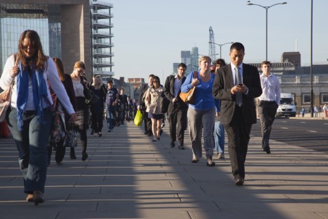 England, London, Early morning commuters crossing London Bridge towards the City Financial district