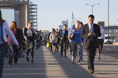England, London, Early morning commuters crossing London Bridge towards the City Financial district