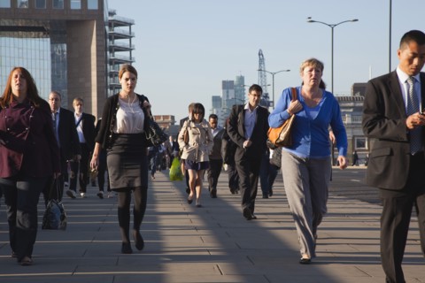 England, London, Early morning commuters crossing London Bridge towards the City Financial district
