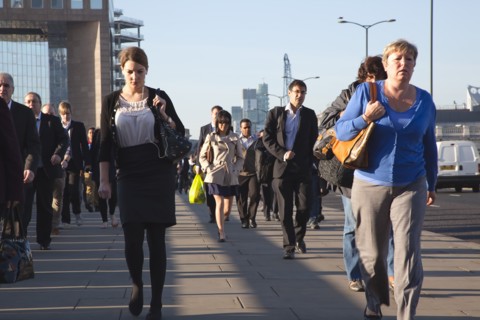 England, London, Early morning commuters crossing London Bridge towards the City Financial district