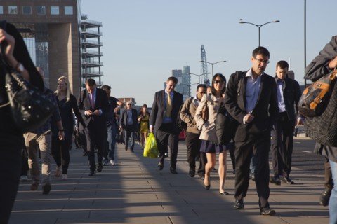 England, London, Early morning commuters crossing London Bridge towards the City Financial district