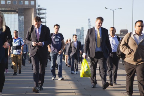 England, London, Early morning commuters crossing London Bridge towards the City Financial district