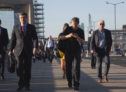 England, London, Early morning commuters crossing London Bridge towards the City Financial district
