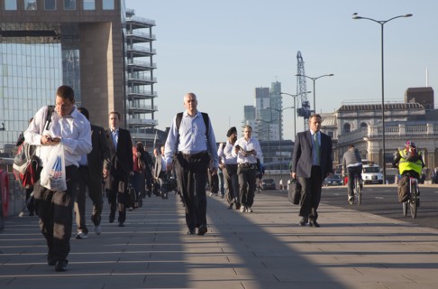England, London, Early morning commuters crossing London Bridge towards the City Financial district