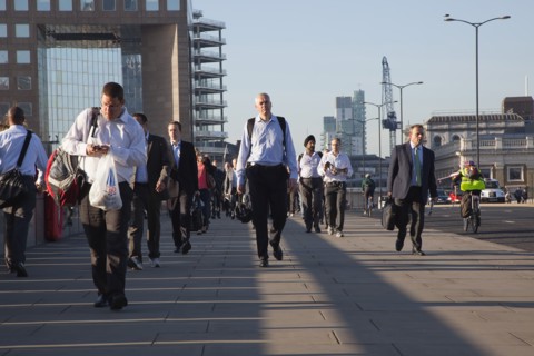 England, London, Early morning commuters crossing London Bridge towards the City Financial district