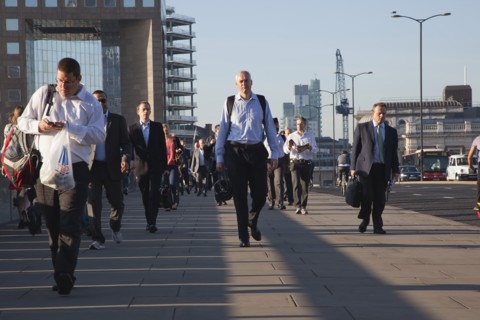 England, London, Early morning commuters crossing London Bridge towards the City Financial district