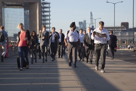 England, London, Early morning commuters crossing London Bridge towards the City Financial district