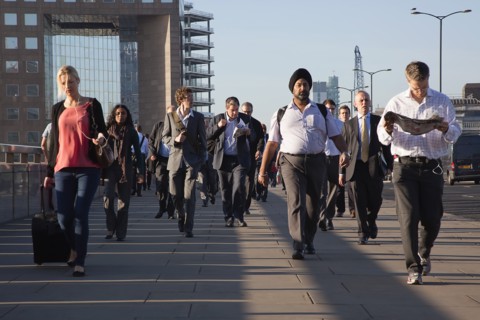 England, London, Early morning commuters crossing London Bridge towards the City Financial district