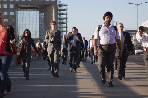 England, London, Early morning commuters crossing London Bridge towards the City Financial district