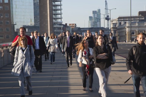 England, London, Early morning commuters crossing London Bridge towards the City Financial district