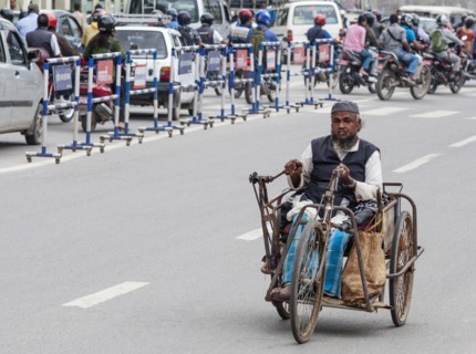 Nepal, Kathmandu, Old man using hand pedal powered tricycle. Photo : Sergey Orlov