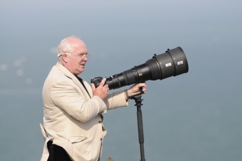 England, East Sussex, Beachy Head, Plane enthusiast photographing air display with long lens on a