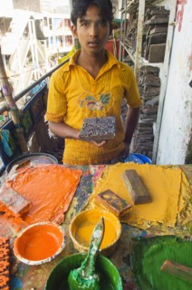 Bangladesh, Dhaka, Young man holding a printing block used to print on cotton fabrics in New Market