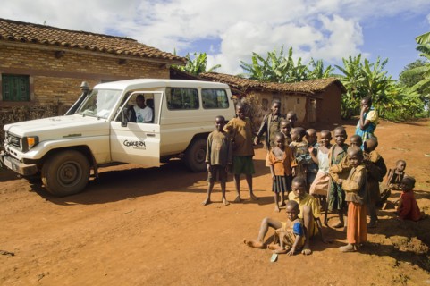 Rwanda, Children, Group of children on road beside a development project vehicle. 
Photo Nic I