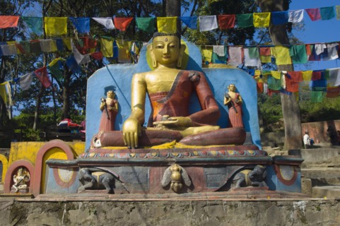 Nepal, Kathmandu, Buddha statue at the foot of the Swayambunath Monkey Temple. 
Photo Nic I Anson