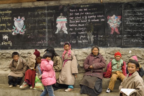 China, Szechuan Province, Tibet, Parents grandparents and children at the entrance to a private