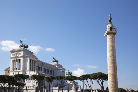 Italy, Lazio, Rome, Victor Emmanuel II monument with Trajans Column in the foreground. 
Photo