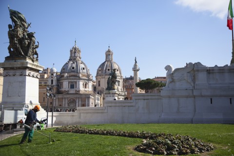 Italy, Lazio, Rome, Gardener using strimmer on the grounds of teh Victor Emannuel II monument.