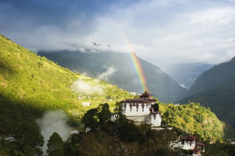 Bhutan, Lhuentse Dzong, Lhuentse Dzong with colourful rainbow overhead. 
Photo Nic I'Anson