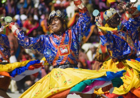 Bhutan, Thimpu Dzong, Dancers in the courtyard during festival. 
Photo Nic I'Anson