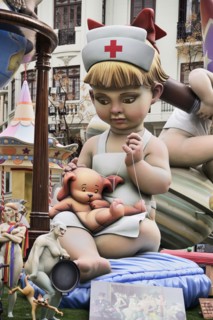 Spain, Valencia Province, Valencia, Papier Mache figure of young girl in nurses outfit with teddy