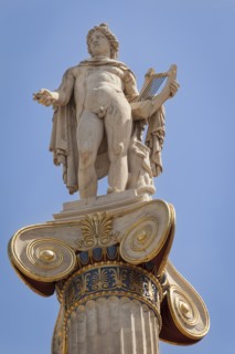 Greece, Attica, Athens, Statue of Apollo outside the Academy of Arts. 
Photo Mel Longhurst