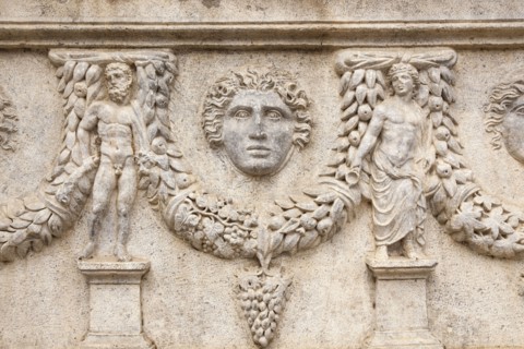 Egypt, Alexandria, Carved stone detail on a sarcophagus at The Catacombs of Kom El Shuqafa. 
Photo