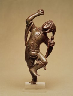 Jester figure forming a stand for candlestick. Germany, 15th century
